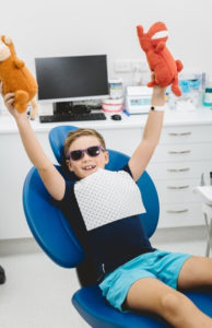 Children's dentistry at Method Dental with a child enjoying their visit in the dental chair
