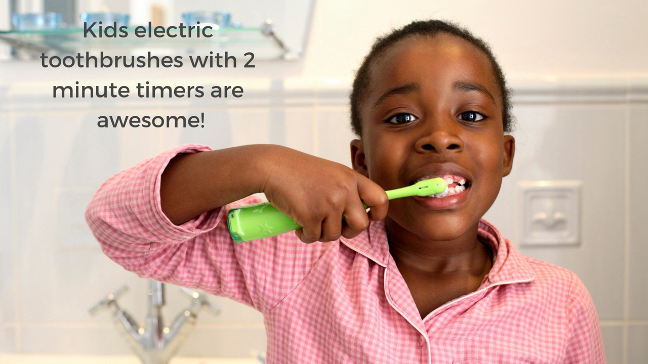 A child using an electric toothbrush with a 2 minute timer
