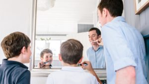 Dr. Grant McGrath brushing his teeth, and the kids are brushing their teeth too