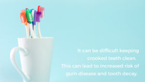 Toothbrushes in a cup with a caption about how hard crooked teeth are to brush properly