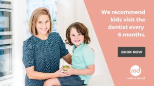 Mum and boy with apple recommending regular dental check ups for kids